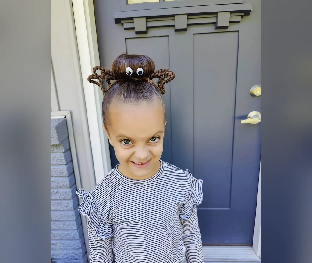 Little girl's spider bun with googly eyes, a sweet idea from halloween hairstyles for girls