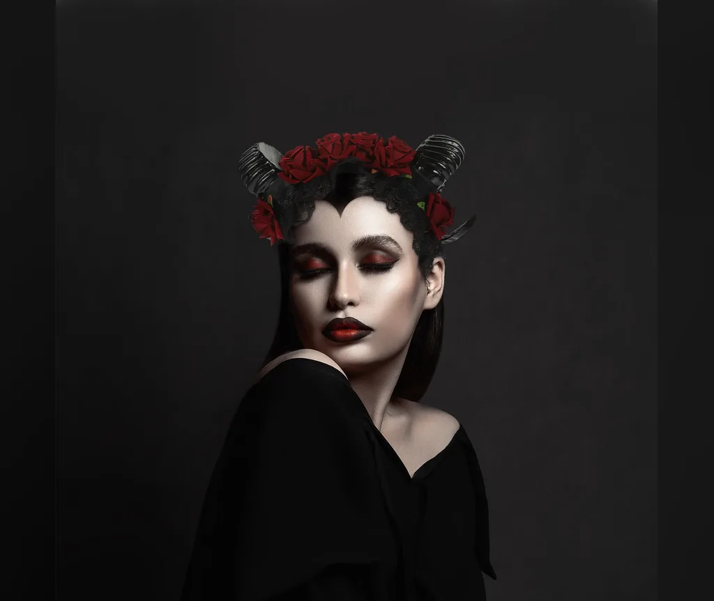 Black horns with a red rose crown over sleek dark hair, romantic gothic halloween hairstyles for women