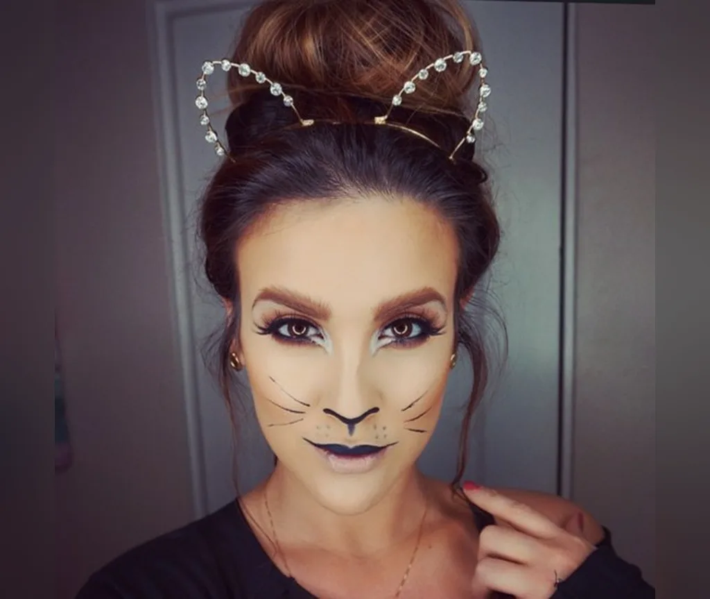 High bun with a crystal cat ear crown and cat makeup, easy elegant halloween hairstyle