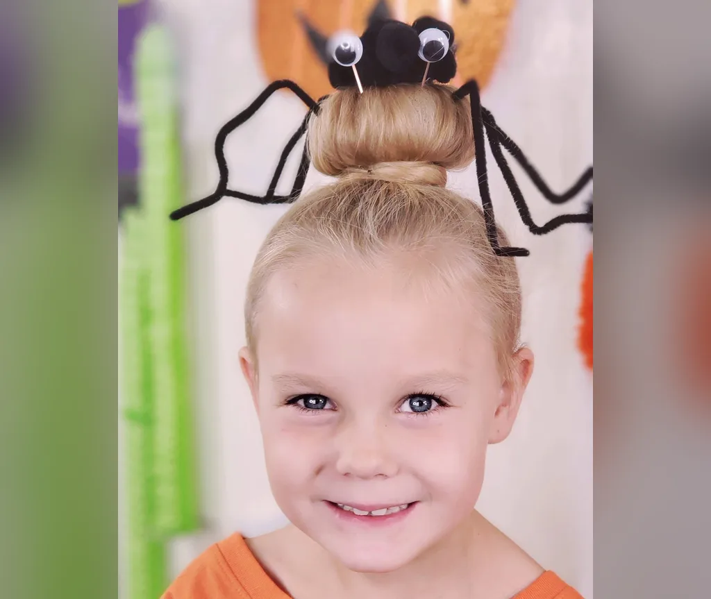 Close up of a blonde spider bun with spider legs and googly eyes, detailed halloween hairstyles for girls