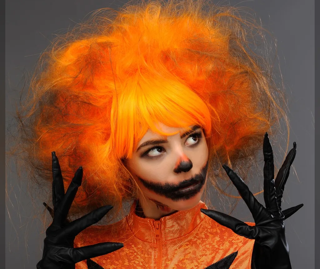 Orange afro wig with pumpkin glam makeup, fun and vibrant halloween hairstyles for women