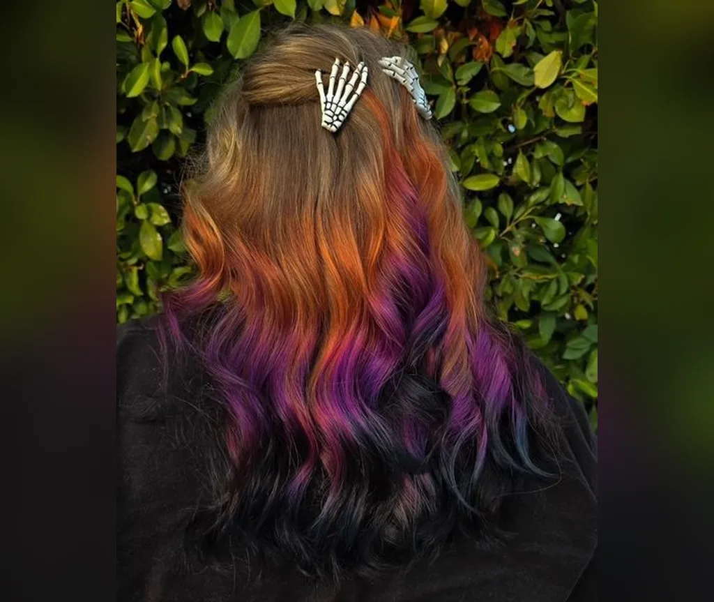 Orange to purple ombre with skeleton clips in halloween hair color ideas