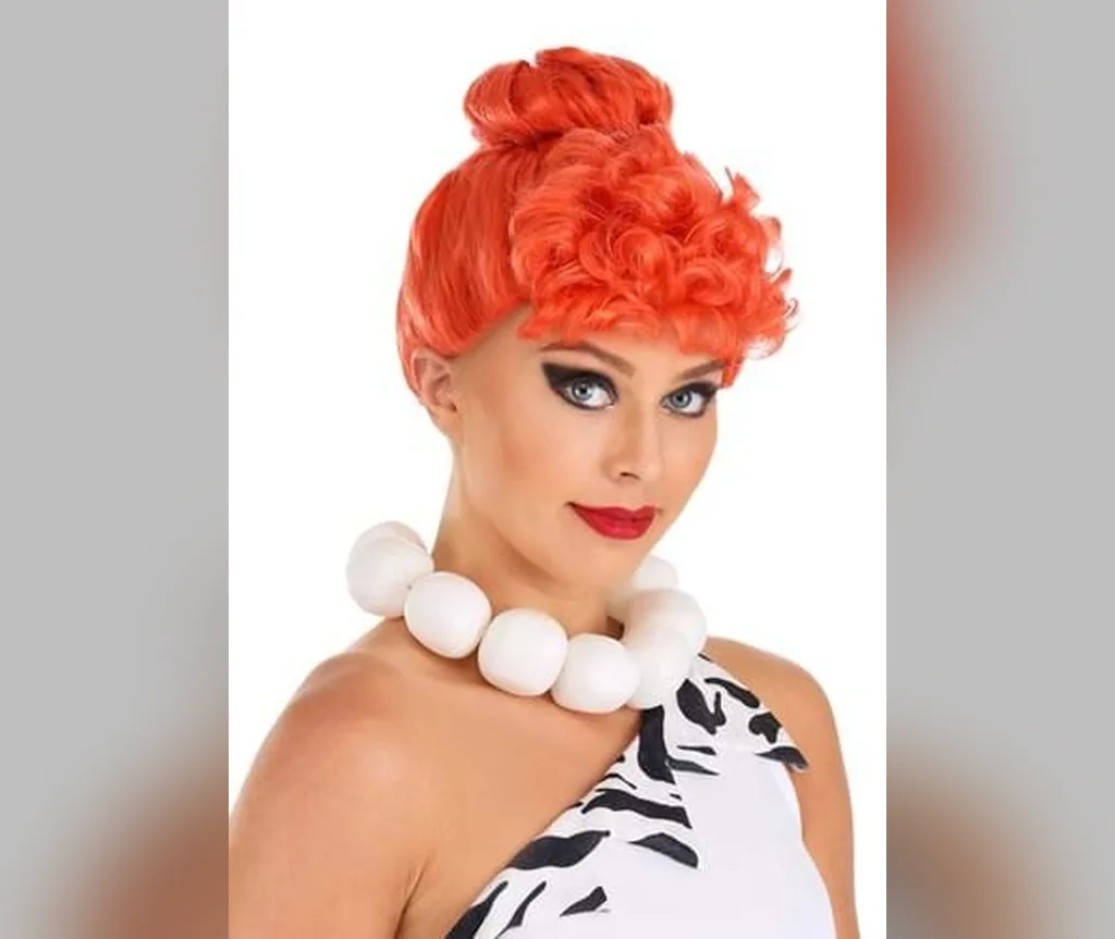 Bright orange curly updo with stone age costume styling, quirky halloween hairstyles for women