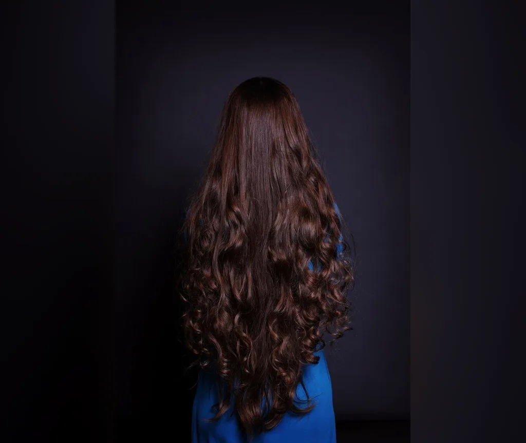 Extremely long dark chocolate waves against a dark background, glamorous halloween hair for long hair