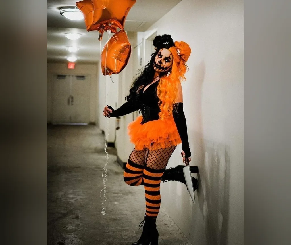 Clown costume with half black half orange hair, colourful halloween hairstyles for women for circus looks