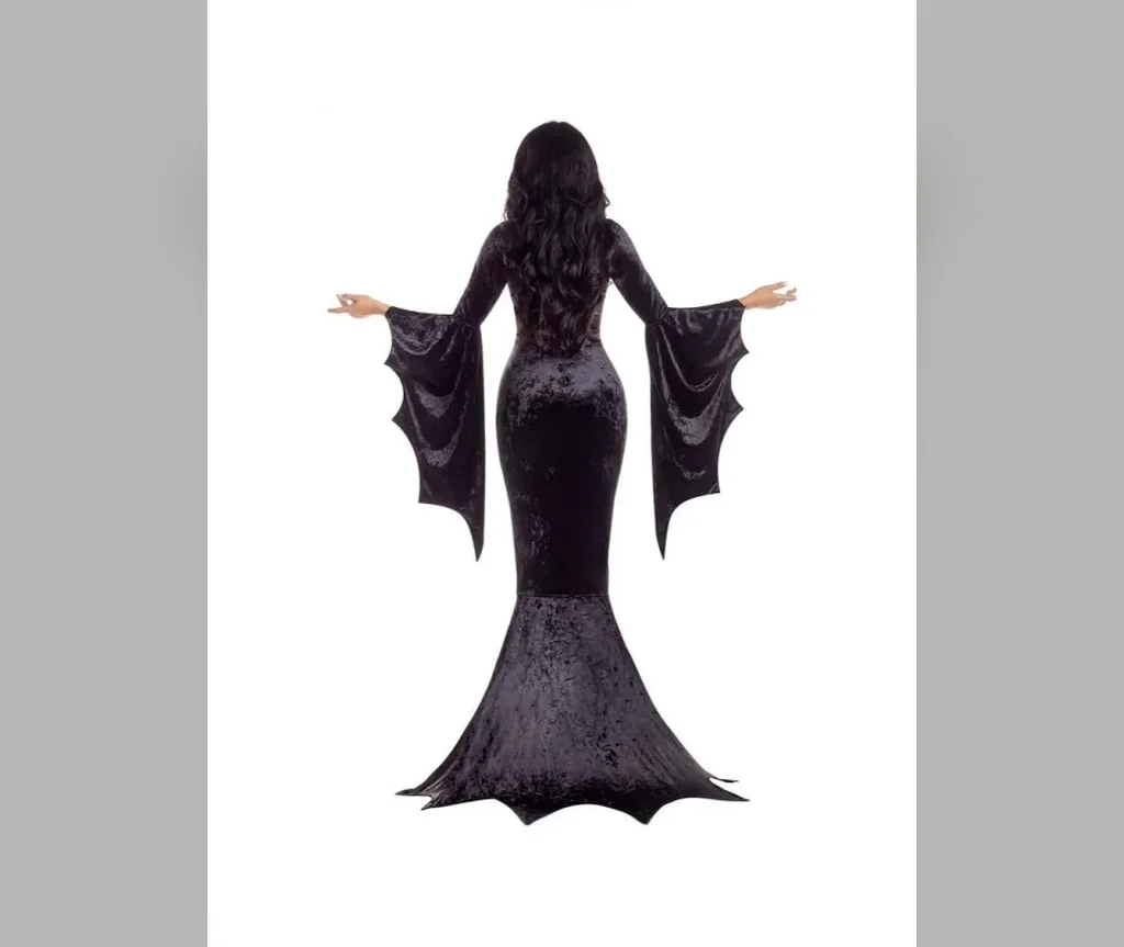 Full figure in a black velvet gown with long black Morticia style waves, iconic halloween hair for long hair