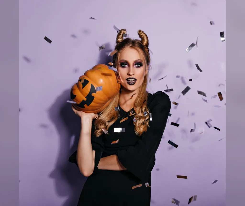 Twisted horn buns with a pumpkin and confetti, fun no-headband Halloween hairstyle