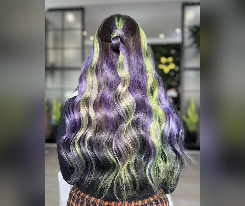 Purple waves with neon green streaks in halloween hair color ideas