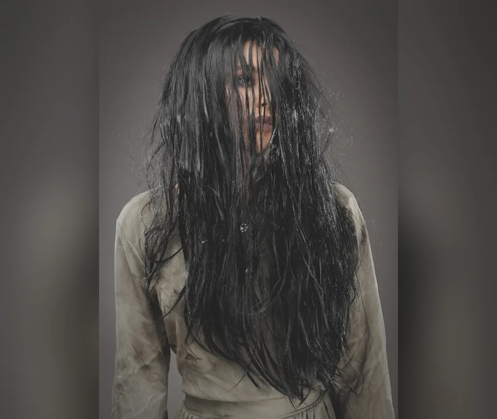 Very long black hair falling over the face, ghostly halloween hairstyles for women for a haunted look