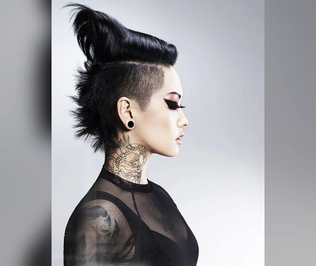 Towering black mohawk with tattooed styling