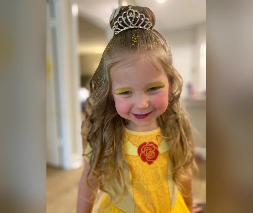 Half up bun with a tiara and soft loose hair, halloween hairstyles for girls