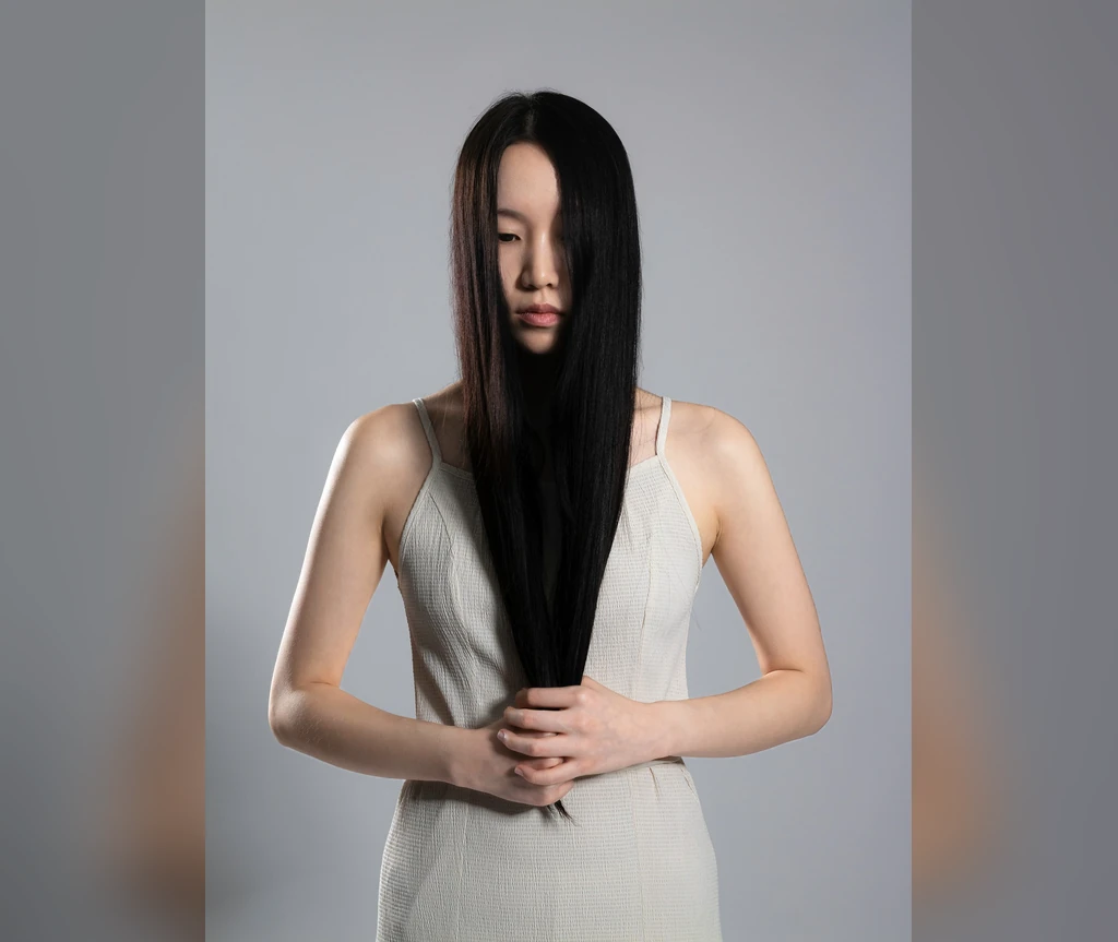 Curtain of black hair falling over the face