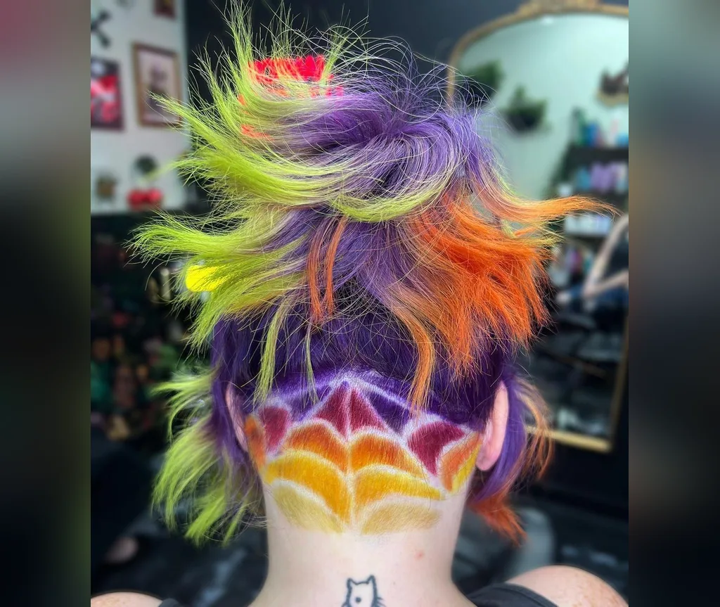 Neon spiderweb pixie with a shaved web design in halloween hair color ideas