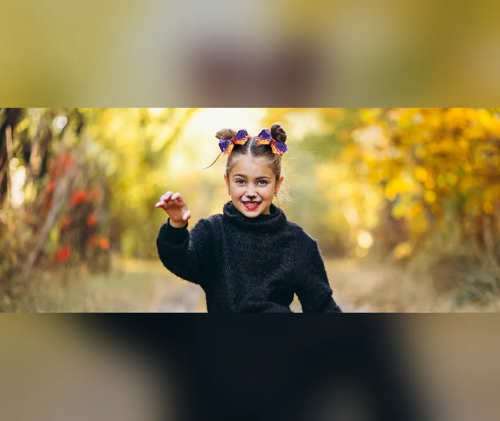High cat ear buns with Halloween bows outdoors, halloween hairstyles for girls