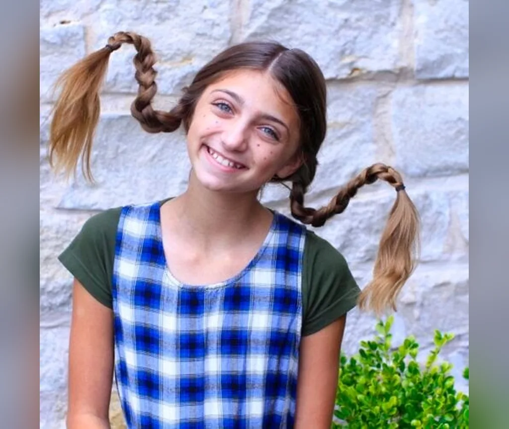 Two braids bent upward in playful Pippi style, halloween hairstyles for girls
