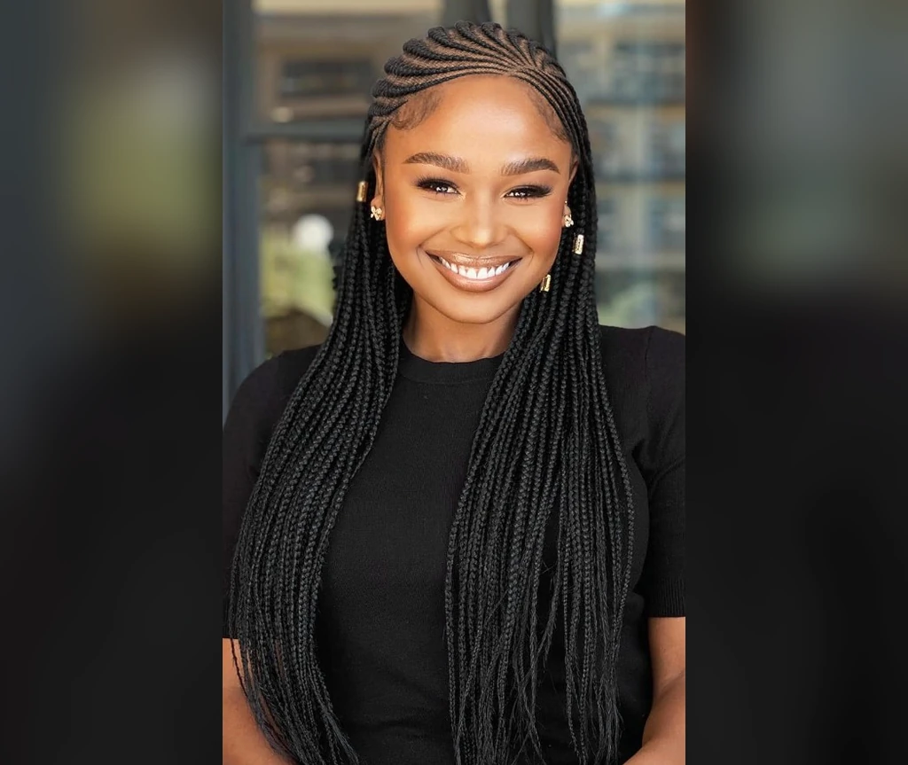 Long waist-length cornrows on a smiling woman