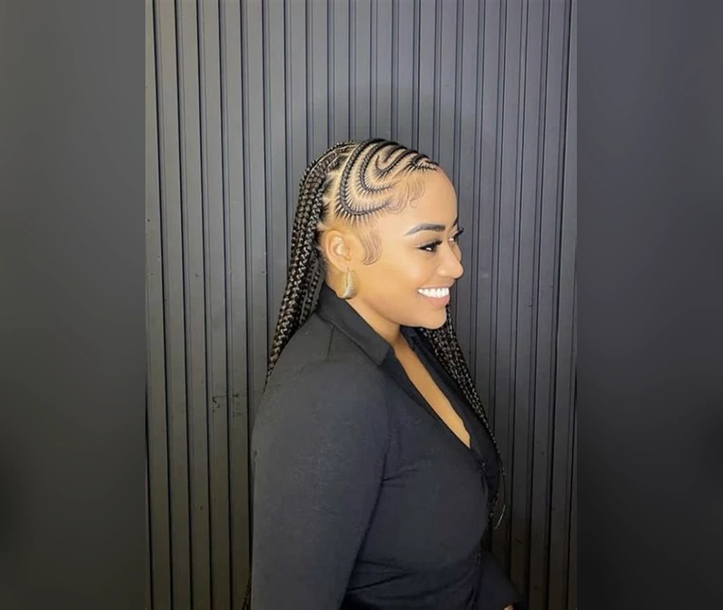 Cornrows with a swirl pattern curving across the scalp