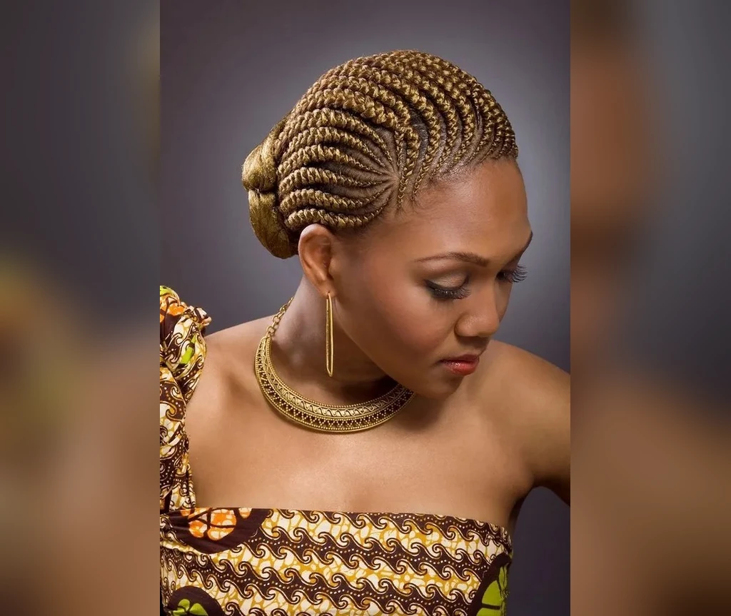 Golden blonde Ghana braids with an elegant low bun
