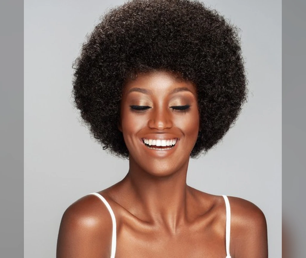 Short afro hairstyles - smiling woman with a classic rounded afro
