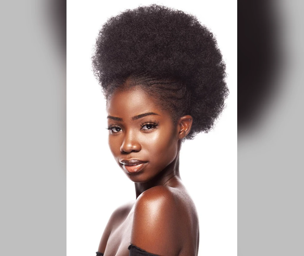 Afro puff on a Black woman against a white background