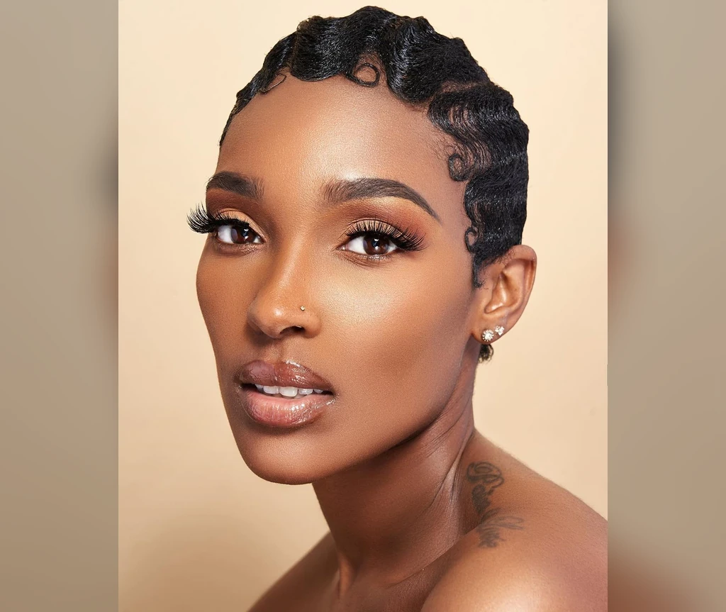 Finger waves on a Black woman with a sculpted glossy finish