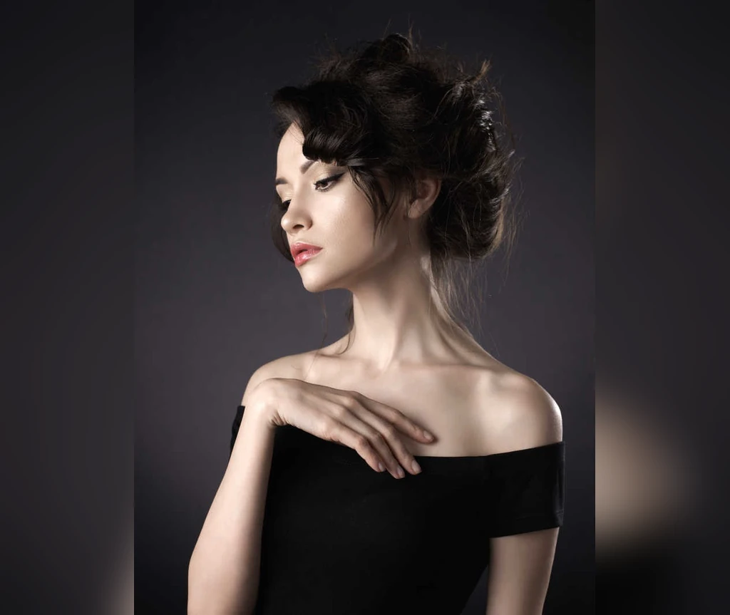 Dark updo with loose face-framing strands